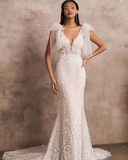66212 by lillian west Bridal.
Lillian West Bridal Stockists in Northern Ireland.
Beaded Fit and Flare Dress with Detachable Shoulder Bows
Organic and ethereal, this fit and flare bridal dress will have you looking out of this world. Featuring a daring plunging V-neck, the sheer bodice is accented with illusion side insets and a V-back. Sequined and beaded appliqués are blended with 3D laser cut chiffon appliqués that float throughout the gown. Detachable tulle shoulder bows add a soft and feminine touch. Designed with curve contouring shapewear mesh lining, your hourglass shape will be defined. Tulle covered buttons accent the back of the gown drawing the eye to the chapel length train. For added structure, this style is also available with the bodice lined to the side illusion insets.
COLOR SHOWN IN
Nude/Ivory/Nude
COLORS
Nude/Ivory/Nude, Ivory/Ivory/Nude, Sand/Ivory/Nude
SILHOUETTE
Fit and Flare
NECKLINE
V-Neck, Plunge
WAISTLINE
Natural
TREND
Sexy Boho, Unique Lace, Eye-Catching Details, Stylish Sleeves, Soft Romance, Lightweight
FIGURE
Curvy
FABRIC
Powermesh Lining, Lace
TRAIN LENGTH
Chapel