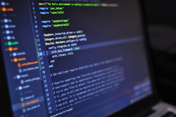 Teacher Writing a Formula on a Blackboard
