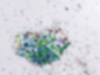 closeup of recycled plastic waste material with speckled appearance