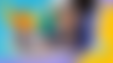 Two smiling students in blue and purple jackets use a laptop together, surrounded by colorful, playful graphics. Mood is joyful and collaborative. A cartoon, orange robot arm extends from the screen.