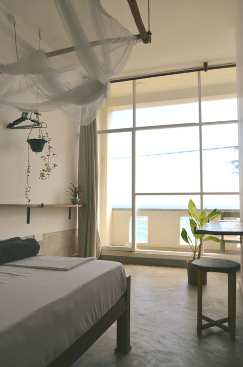Eco-chic, minimalist room with local decor at The Stables Hotel.