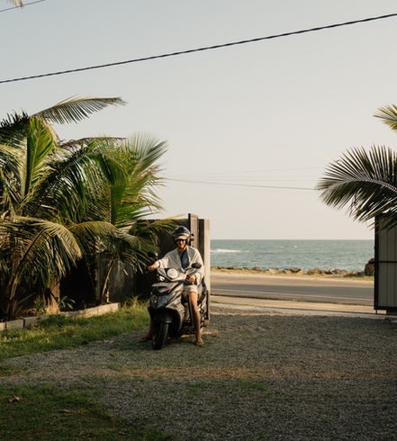 A scooter arriving in the parking lot of The Stables Hotel, ready for the next journey.