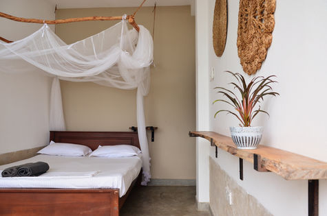 Eco-friendly room with minimalist design and ocean views at The Stables Hotel.