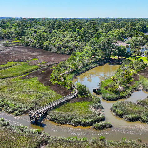Community dock extending into tidal waters behind a waterfront home on Wilmington Island near Savannah