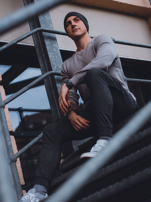 Portrait junger Mann auf Feuertreppe