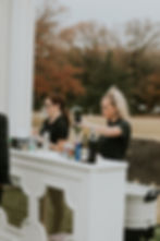2 bartenders serving drinks during cocktail hour