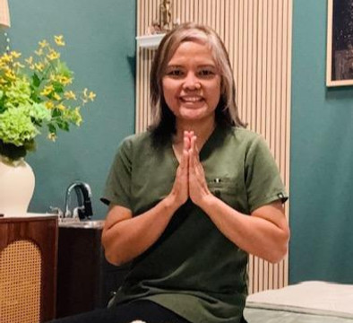 Massage therapist sharing health benefits of therapeutic massage.