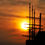 Thumbnail: Silhouette of sailing ship against a bright orange sunset background