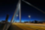 Thumbnail: Night view of a modern bridge with glowing lights and traffic