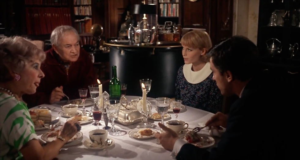 Rosemary, Guy, and the Castevets having dinner