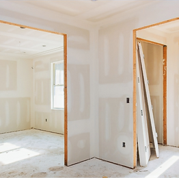 Interior near doorways that has exposed drywall that has been mudded.