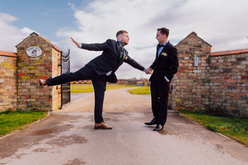 Groom poses playfully; holding hands, Wedding Photography in leeds and yorkshire