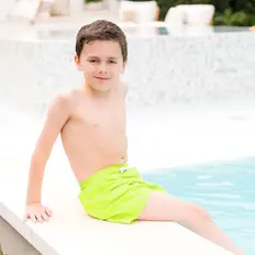 Splash About boys swimwear featuring UV sunsuits, rash tops, wetsuits, and swim shorts for comfort and sun protection