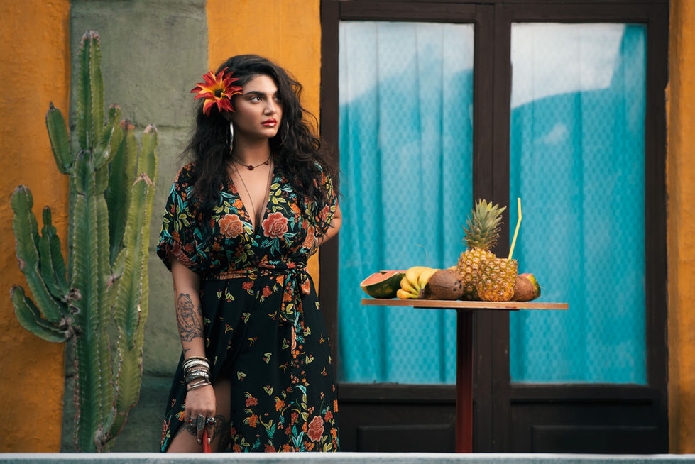 Woman in floral dress with tropical fruit