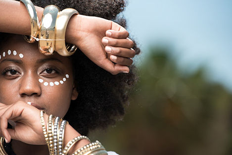 Woman with gold bangles and face paint
