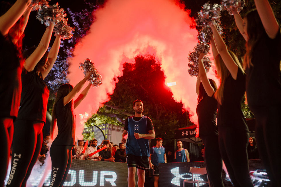 Under Armour event: basketball player with cheerleaders and red smoke