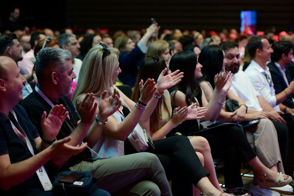 Audience applauding at a conference