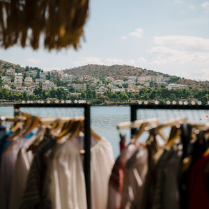 Clothing racks seaside, coastal town backdrop