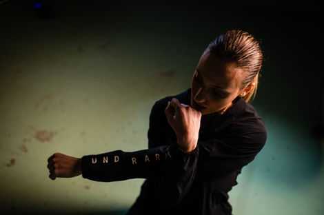 Woman in Under Armour top, boxing stance. korakaki