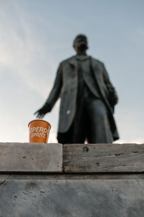 Orange Papercup near statue