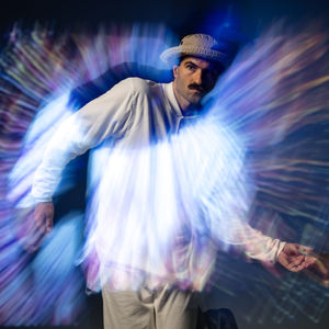Man in hat, light trails, dynamic pose