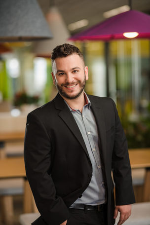 Smiling man in black suit