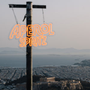 Aperol Spritz neon sign overlooking city