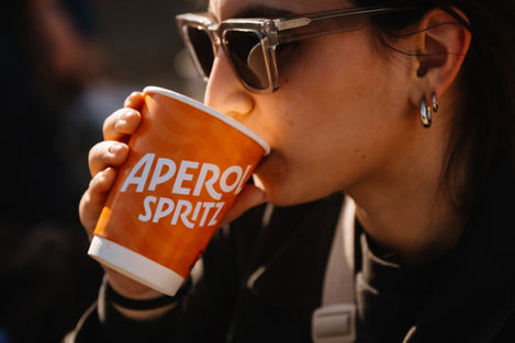 Woman enjoys Aperol Spritz outdoors