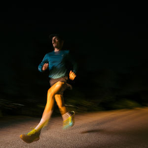 Man running at night on road
