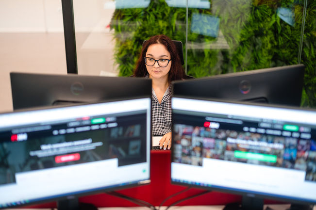 Woman working on computer, website visible