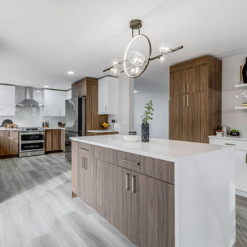 Large kitchen with island and coffee bar.  Walnut and Matte White cabinets.