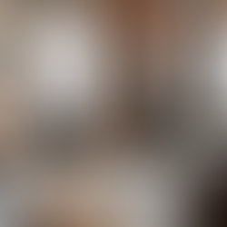 an industrial style living room with exposed brick walls and dark colored furniture and light fixtures