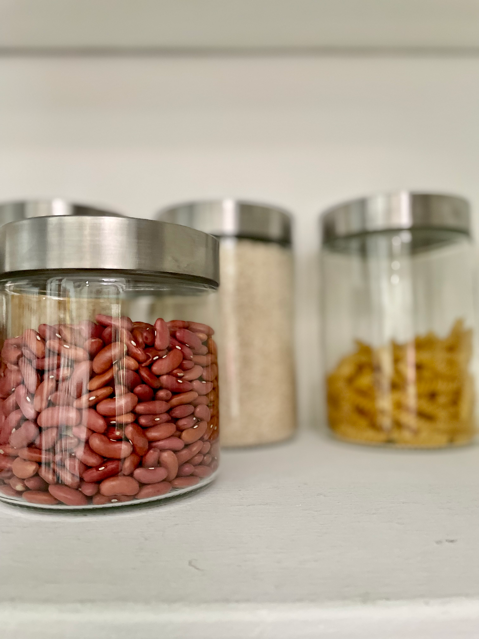 A close up of glass cylinder containers with stainless steel lids