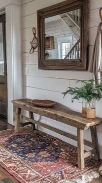 A farmhouse entryway showing a rustic bench by the doorway.