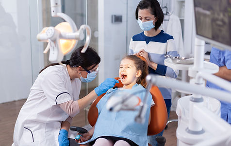 angled-mirror-used-by-dentist-doctor-little-girl-with-mouth-open-dental-office-dentistry-s