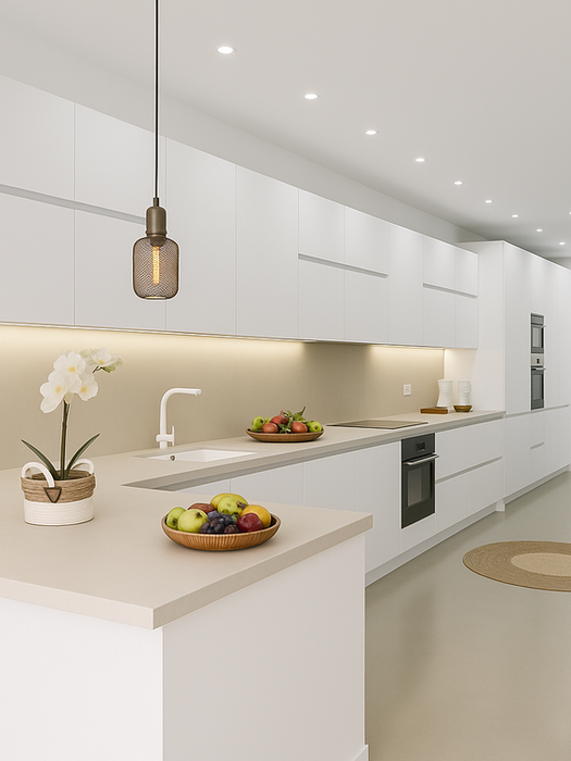 Spacious modern kitchen with white cabinetry, built-in appliances, island counter with fruit bowl, and soft under-cabinet lighting – Can Ferragut Mallorca.