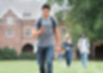 A teenage student walking on campus