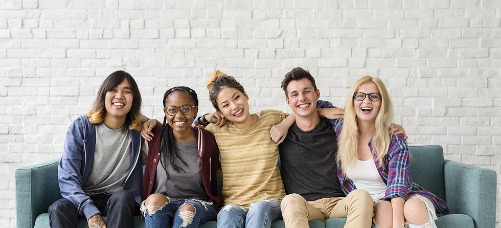 Five students sitting together on a sofa