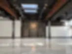 Modern industrial interior at Everett West with exposed brick, concrete floors, and high ceilings