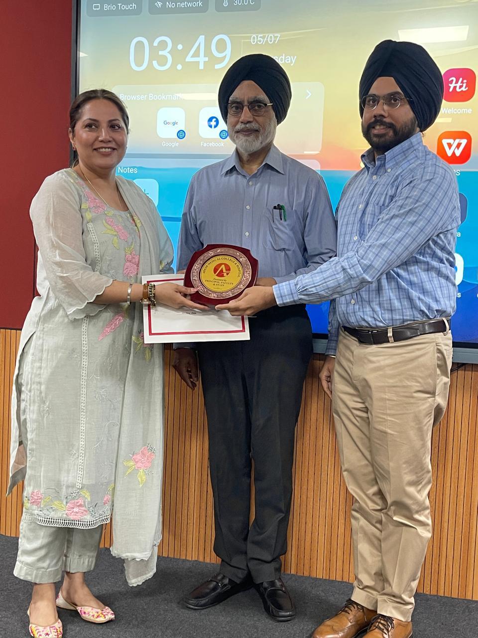 Parneet receiving an award and certificate