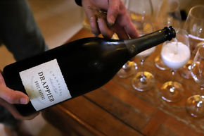 Champagne Drappier's Brut Nature champagne, a cuvée of 100% Pinot Noir grapes with no added liqueur de dosage, is served to visitors in the winery's salon in the village of Urville in the Bar-sur-Aube champagne production region of Eastern France. Drappier is an independent and family-owned house known both for its innovating and crafted champagnes and its dedication to sustainability. 