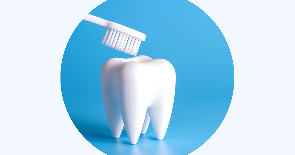 Toothbrush hovering above a large white tooth model against a blue background. No text visible. Clean and bright setting.