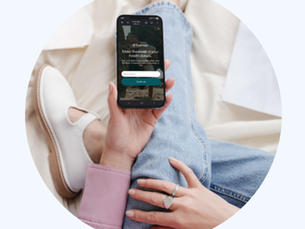 Woman holding phone with Truemed on the screen