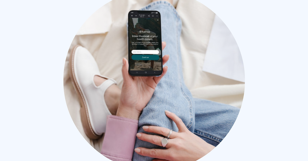 Woman holding phone with Truemed on the screen