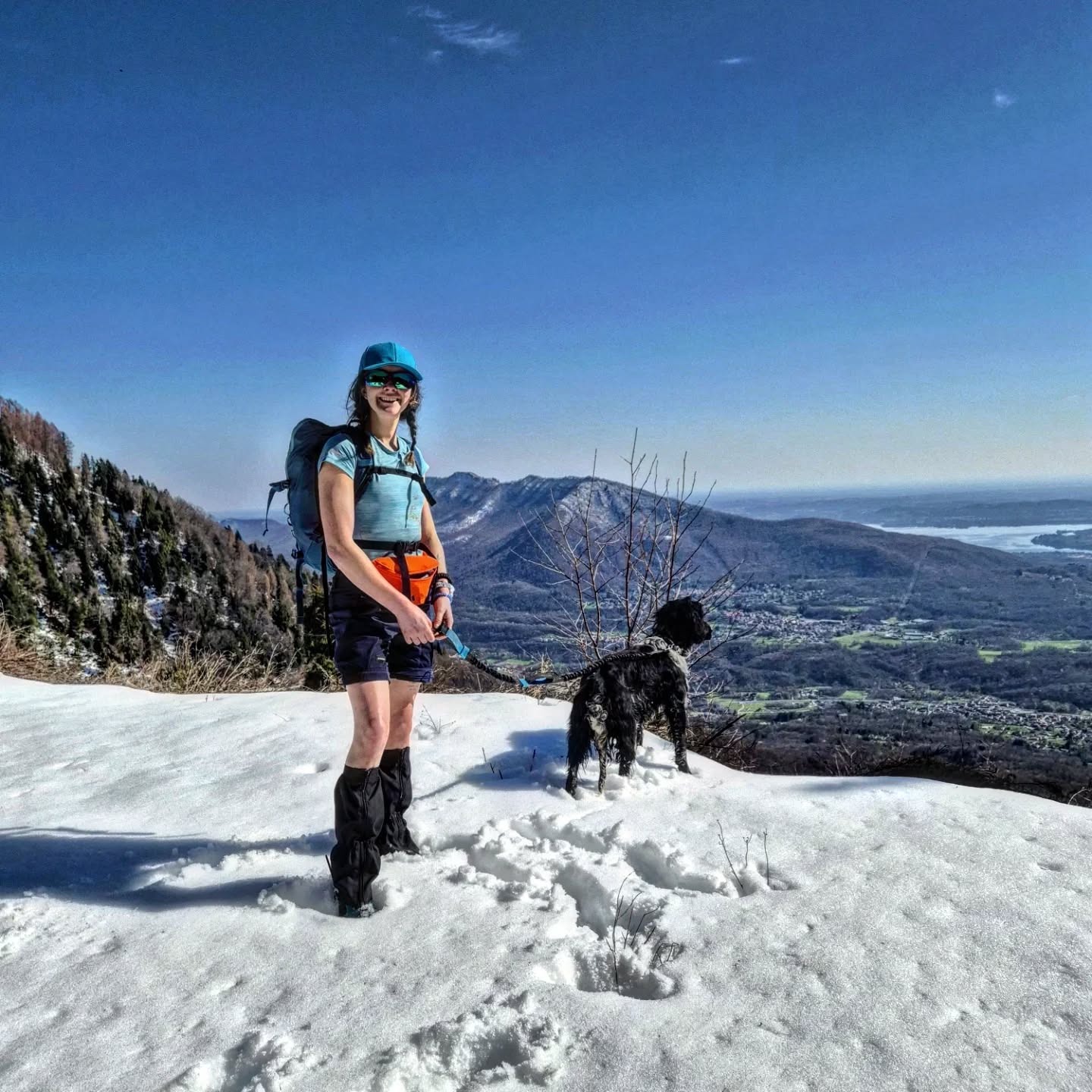 Alessia Masciocchi e il cane Rein sulla neve del Monte Nudo con panorama sul Lago di Varese e Campo dei Fiori