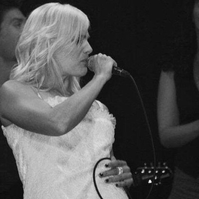 Elfy KA en concert qui danse en robe blanche