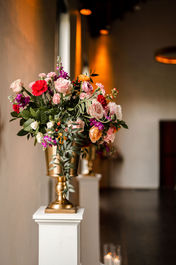 pink and purple altar flowers in gold vase