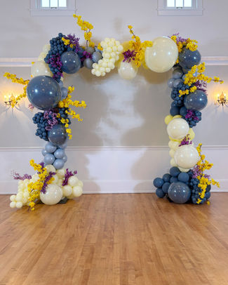 Chic Rectangle Arch with organic balloon garland and floral accents on a freestanding frame