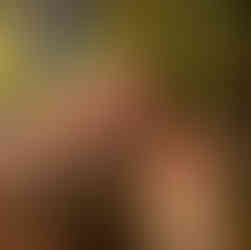 Two girls with sunflowers behind them