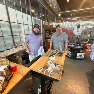 Table with two men standing behind it at a store